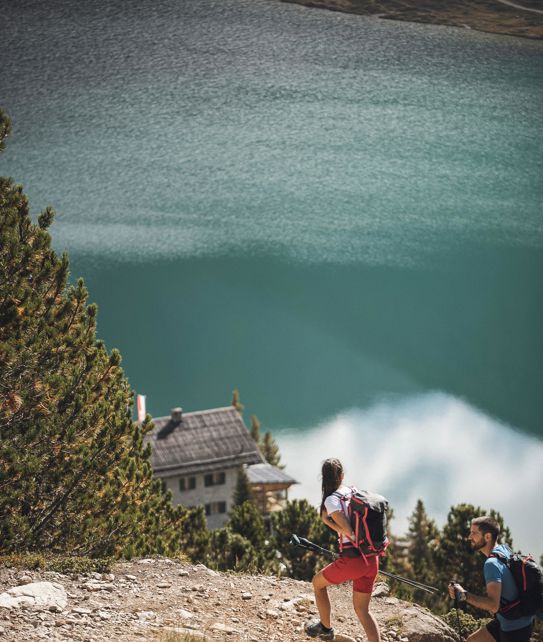 A couple is hiking near a lake
